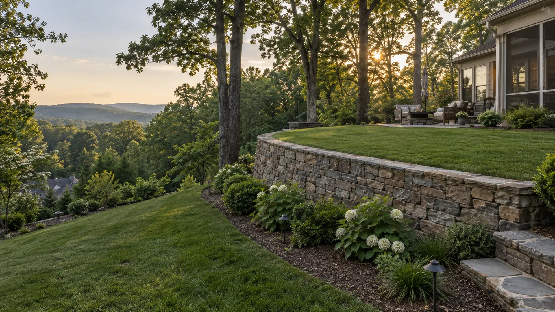 A steep hillside backyard transformed with a retaining wall creating a level lawn terrace above and a gentle slope below, mature oaks on the hill.