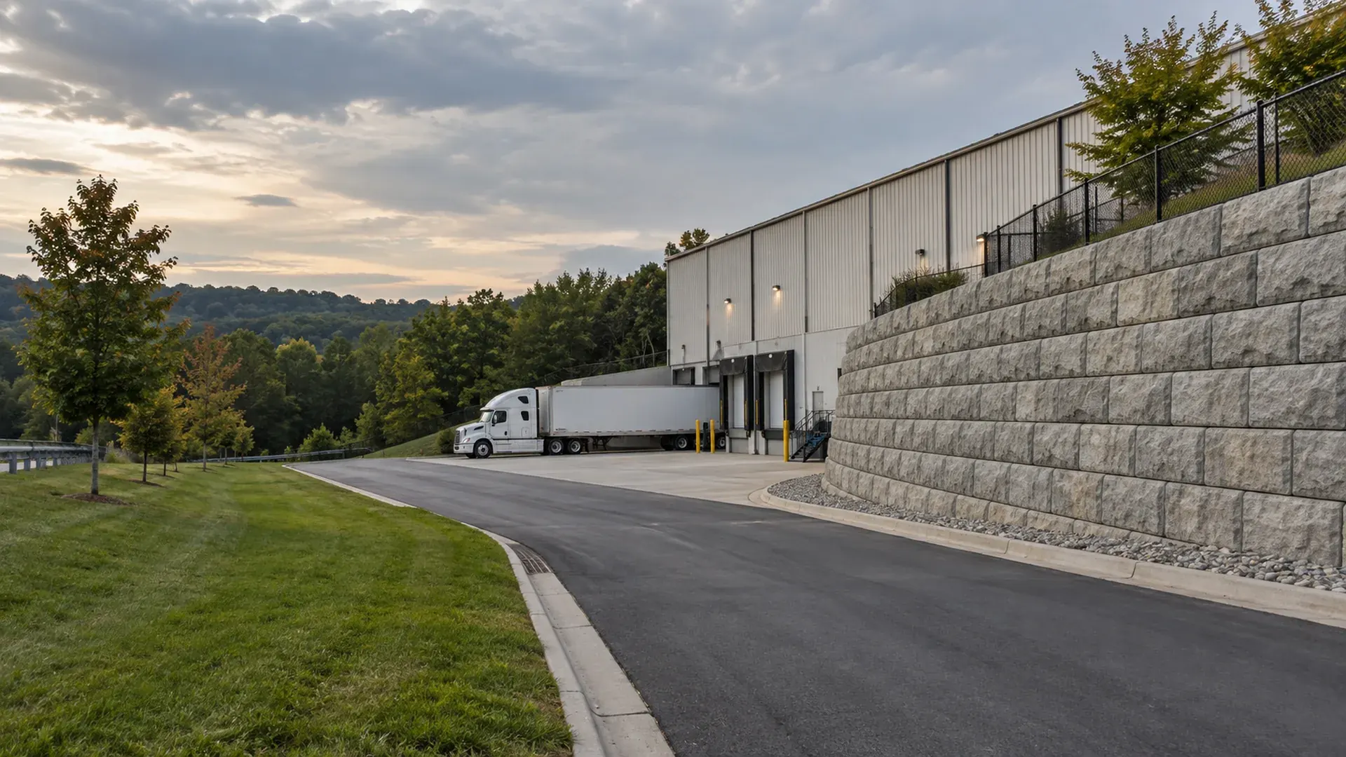 A commercial area in Bellwood, Virginia with a large precast block retaining wall beside a truck route and a warehouse. A commercial area in Bellwood, Virginia with a large precast block retaining wall beside a truck route and a warehouse.