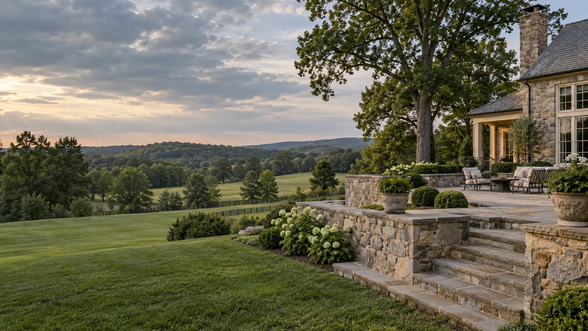 An estate property in Goochland County, Virginia with natural stone terrace walls overlooking rolling fields and a distant tree line. An estate property in Goochland County, Virginia with natural stone terrace walls overlooking rolling fields and a distant tree line.